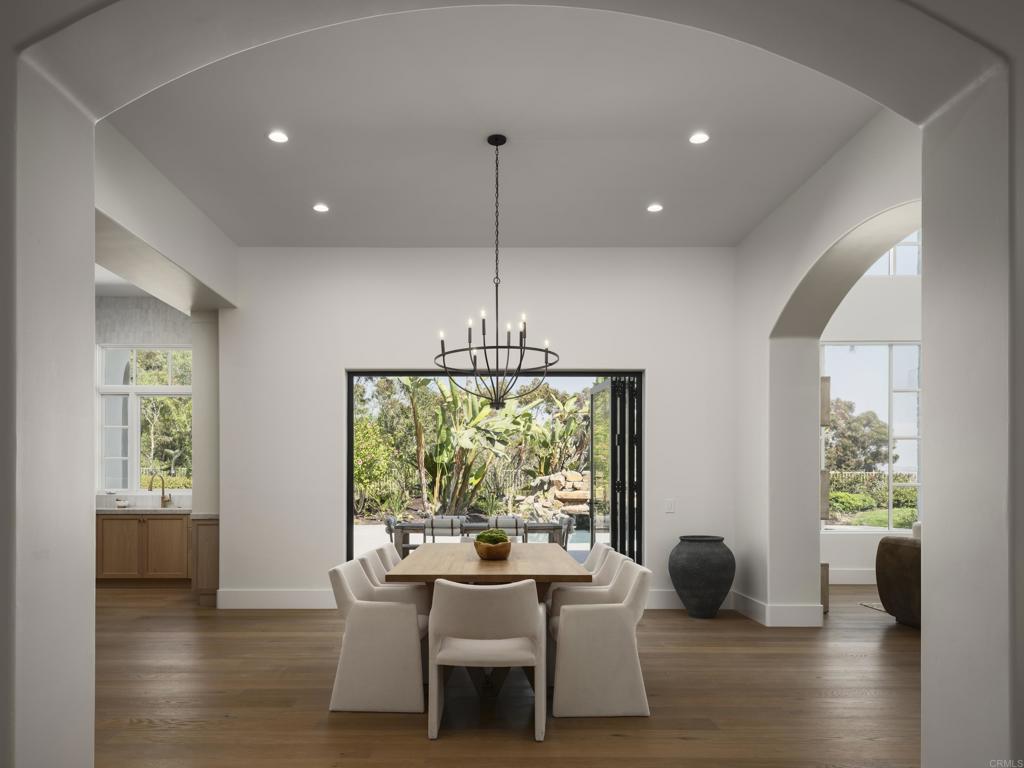 5146 Rancho Verde Trail San Diego, CA 92130 - Photo 13 of 34 a dining room with wooden floor and windows