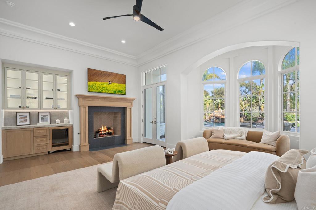 5146 Rancho Verde Trail San Diego, CA 92130 - Photo 15 of 34 a bedroom with furniture and a fireplace