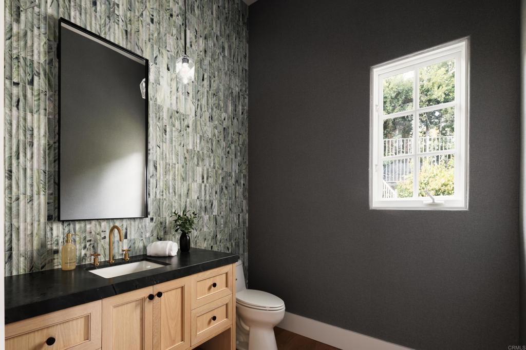 5146 Rancho Verde Trail San Diego, CA 92130 - Photo 19 of 34 a bathroom with a granite countertop sink toilet and mirror
