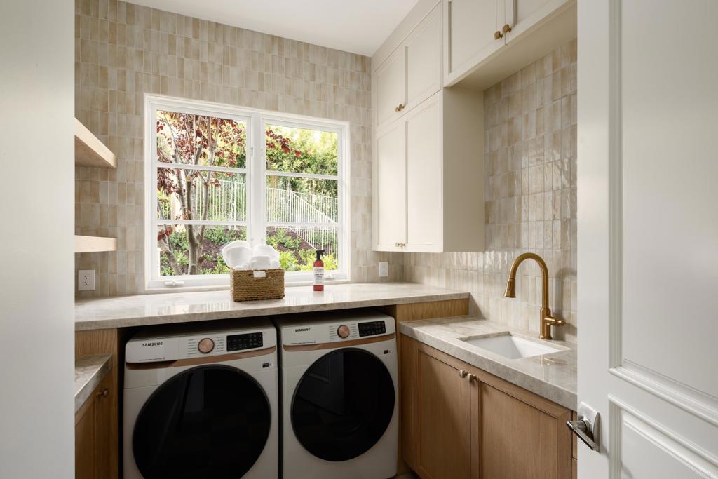 5146 Rancho Verde Trail San Diego, CA 92130 - Photo 20 of 34 a view of a kitchen with sink washer and dryer