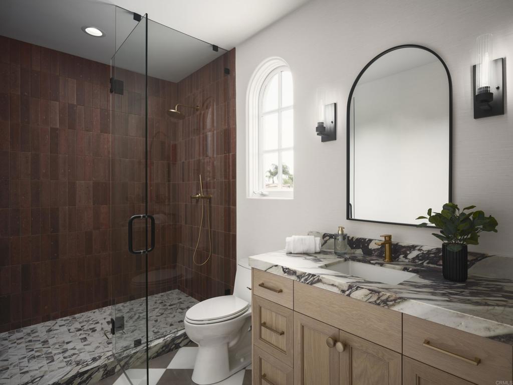 5146 Rancho Verde Trail San Diego, CA 92130 - Photo 23 of 34 a bathroom with a granite countertop sink a toilet and shower