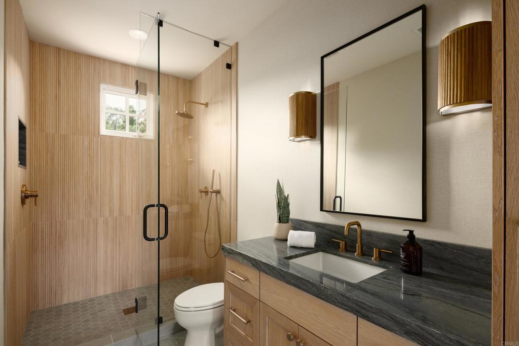 5146 Rancho Verde Trail San Diego, CA 92130 - Photo 25 of 34 a bathroom with a granite countertop sink a toilet a mirror and shower