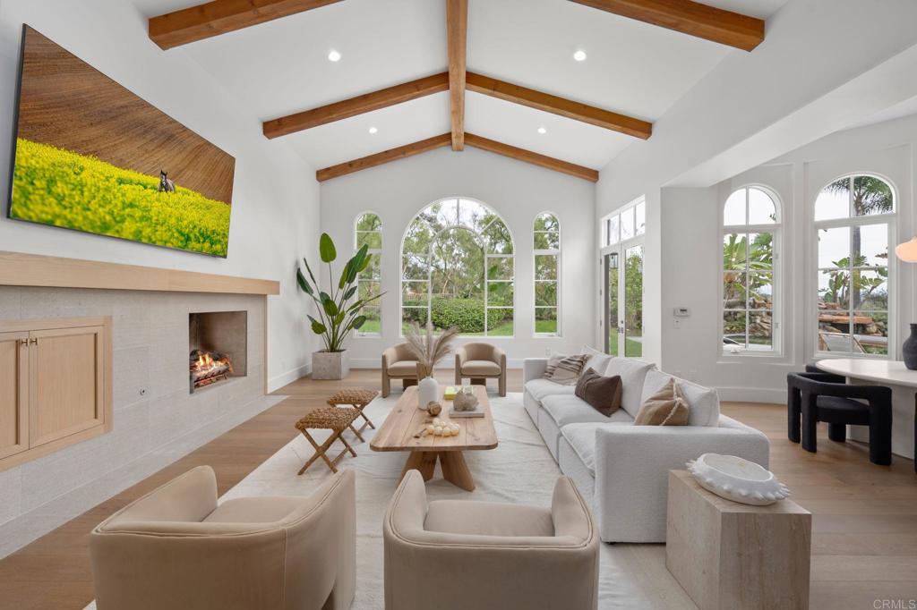 5146 Rancho Verde Trail San Diego, CA 92130 - Photo 5 of 34 a very nice looking living room with a large window a fireplace and a flat screen tv
