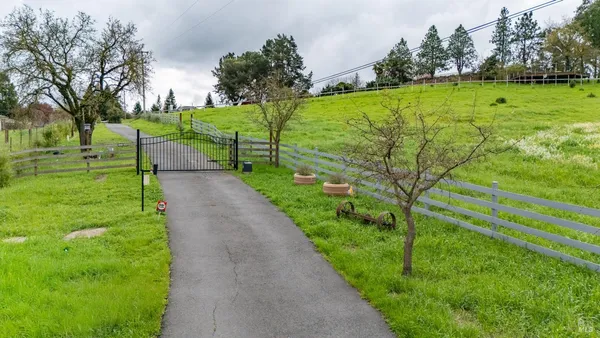 an aerial view of a house with a yard