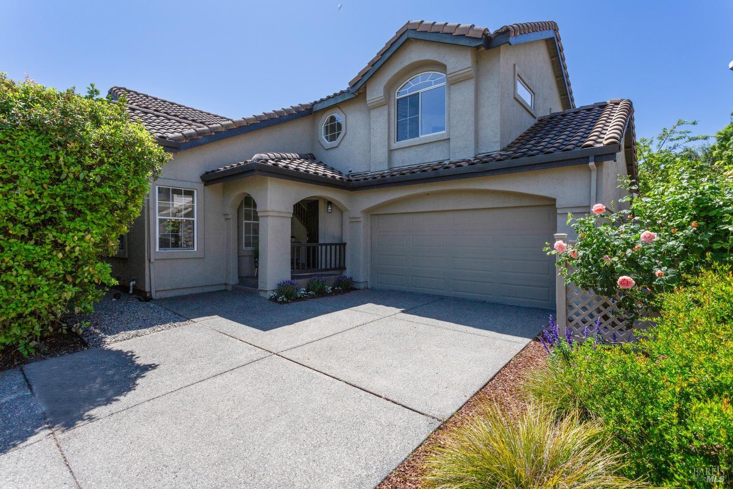 a front view of a house with a garden