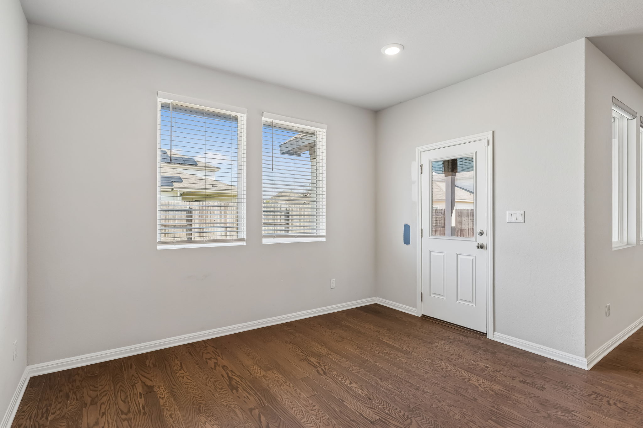 4009 Milano River Road Hutto, TX 78634 - Photo 13 of 40 Rich hardwood flooring complements clean walls and abundant natural light in this versatile room.
