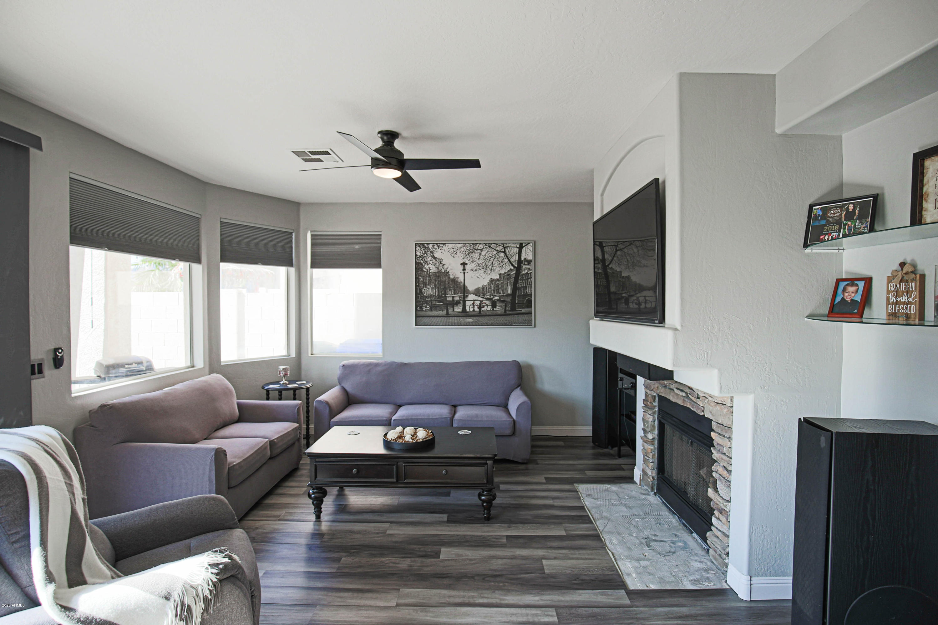 16666 South 21st Street Phoenix, AZ 85048 - Photo 11 of 43 a living room with furniture a flat screen tv and a fireplace