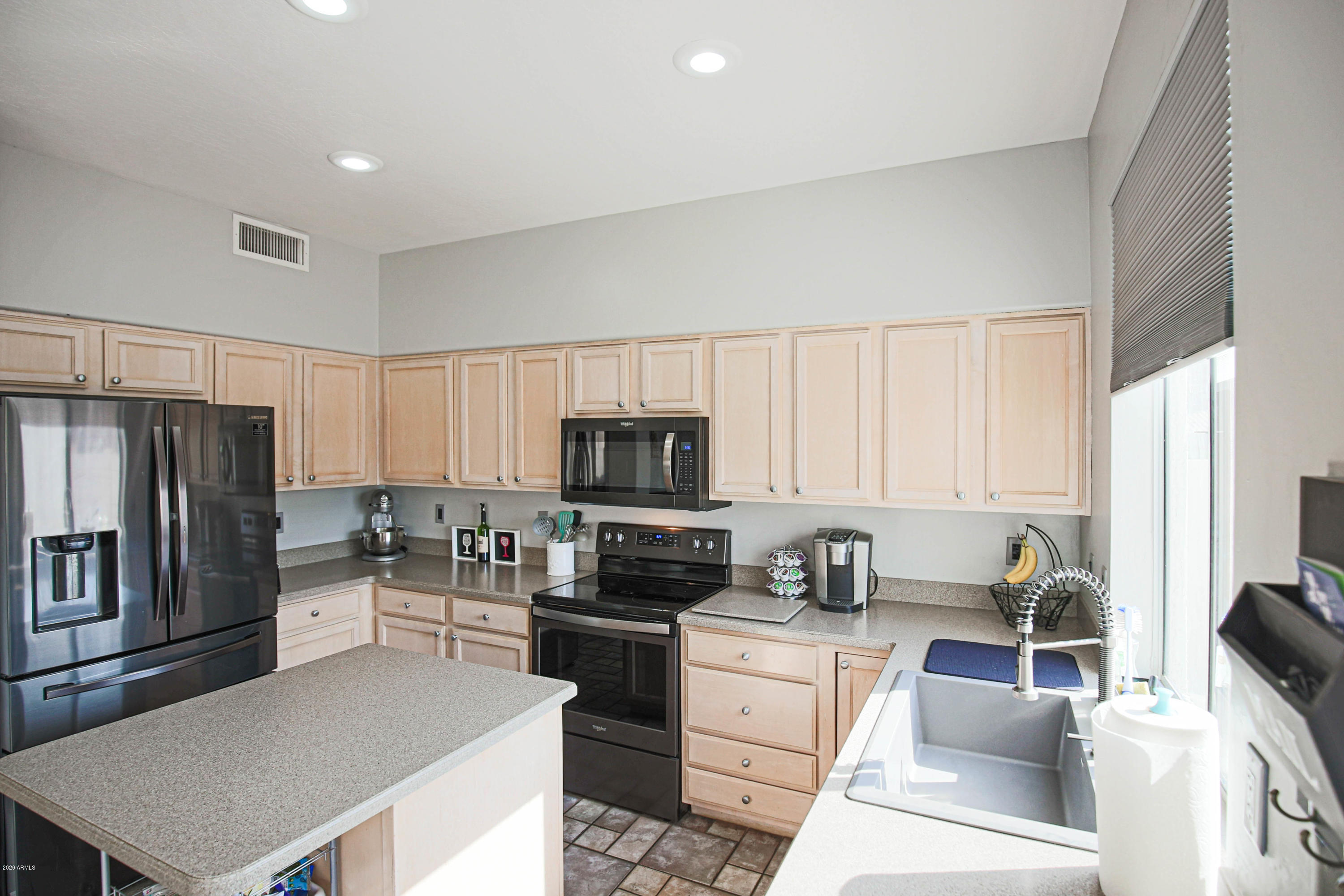 16666 South 21st Street Phoenix, AZ 85048 - Photo 12 of 43 a kitchen with granite countertop a refrigerator stove and sink