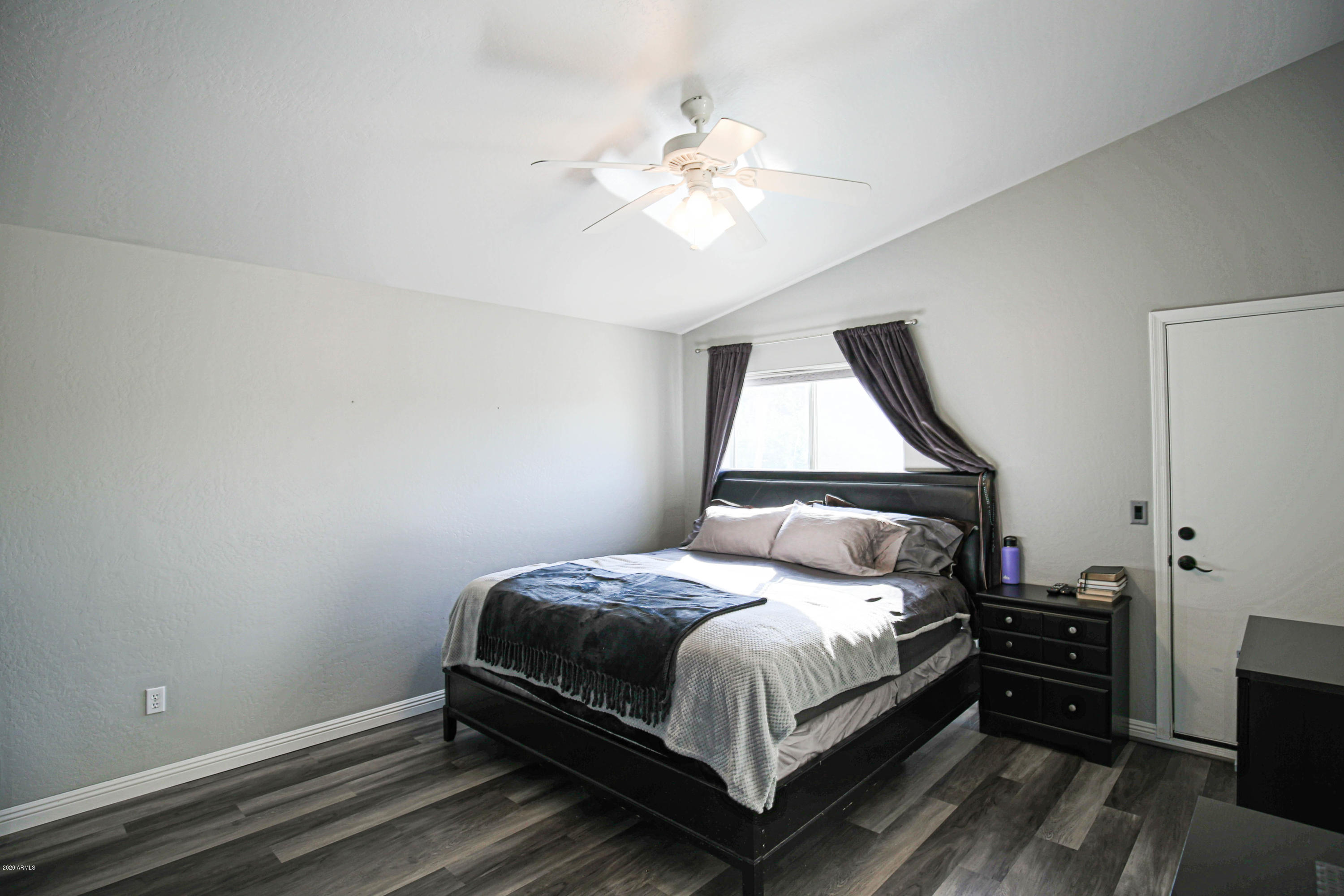 16666 South 21st Street Phoenix, AZ 85048 - Photo 18 of 43 a bedroom with a bed and a chandelier