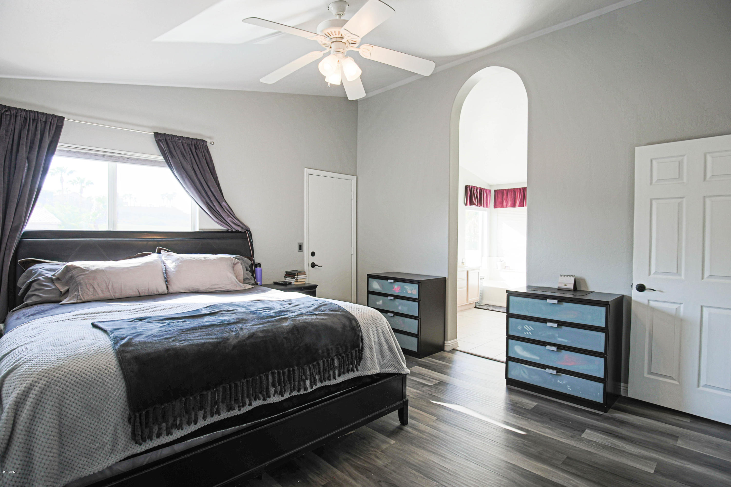 16666 South 21st Street Phoenix, AZ 85048 - Photo 21 of 43 a bedroom with a bed and a chandelier