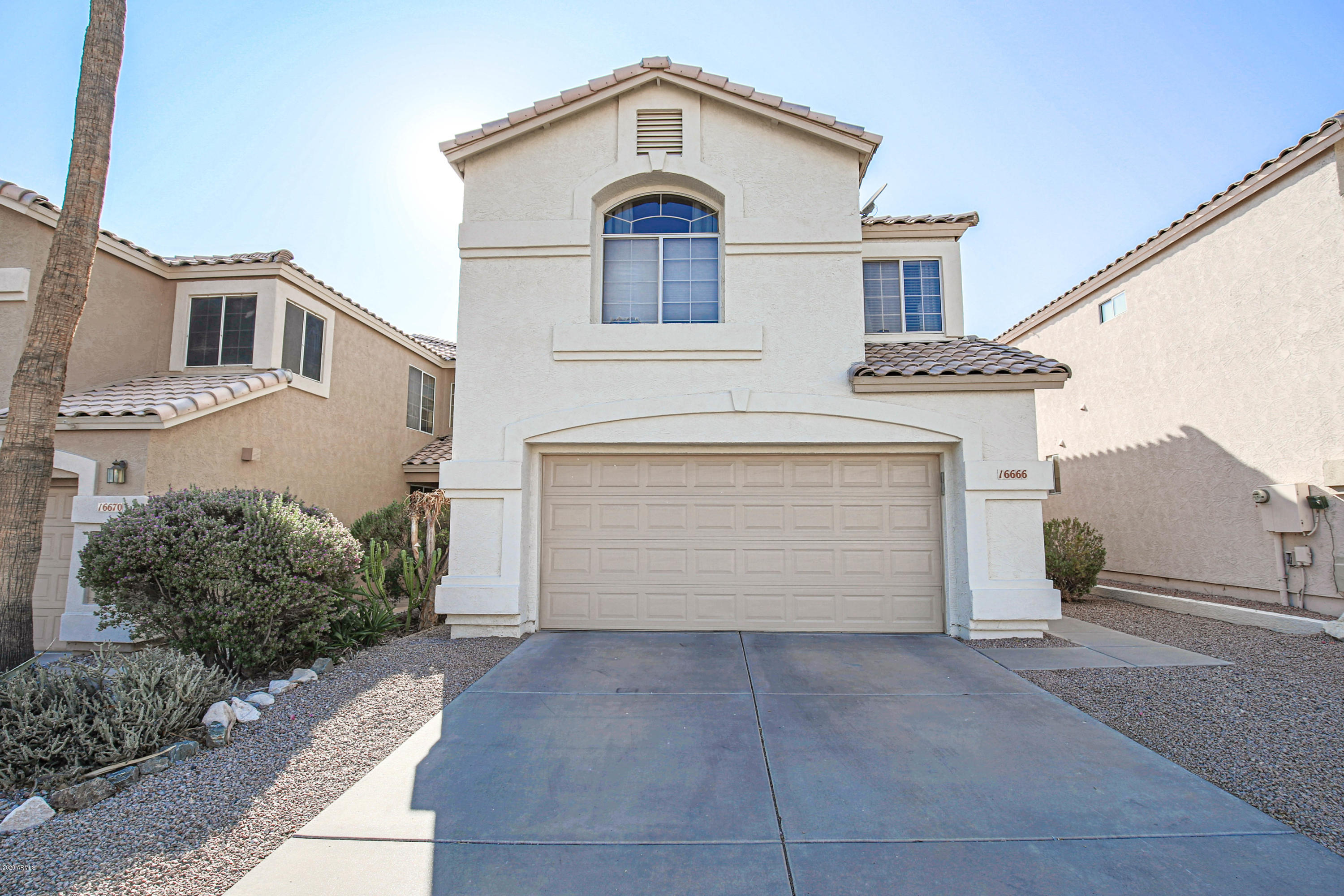 16666 South 21st Street Phoenix, AZ 85048 - Photo 37 of 43 a front view of a house with a yard and garage
