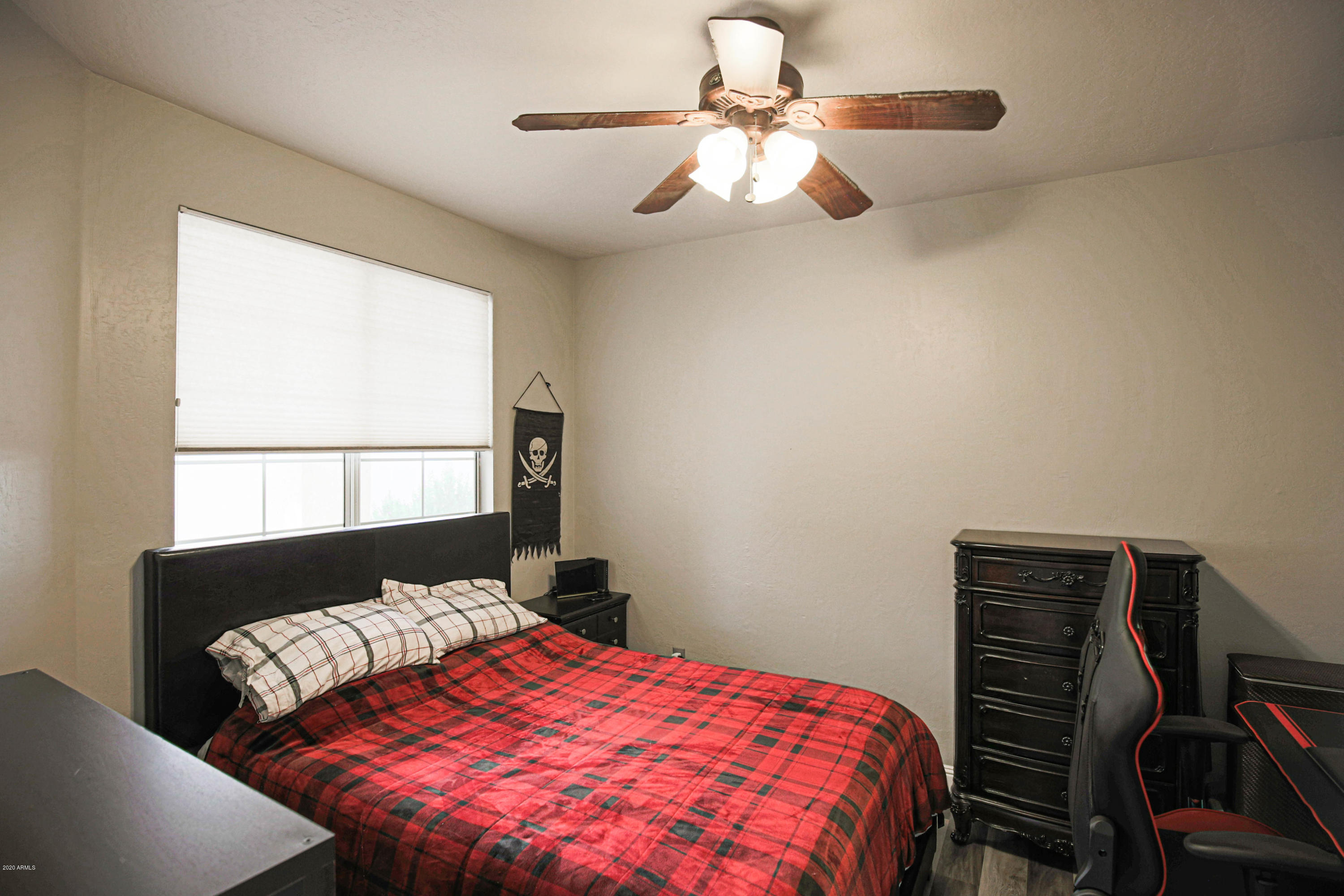 16666 South 21st Street Phoenix, AZ 85048 - Photo 8 of 43 a bedroom with a bed and a chandelier