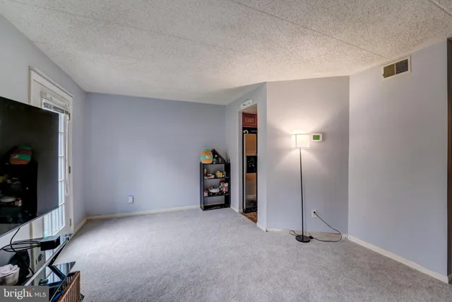 a view of an empty room with a fireplace