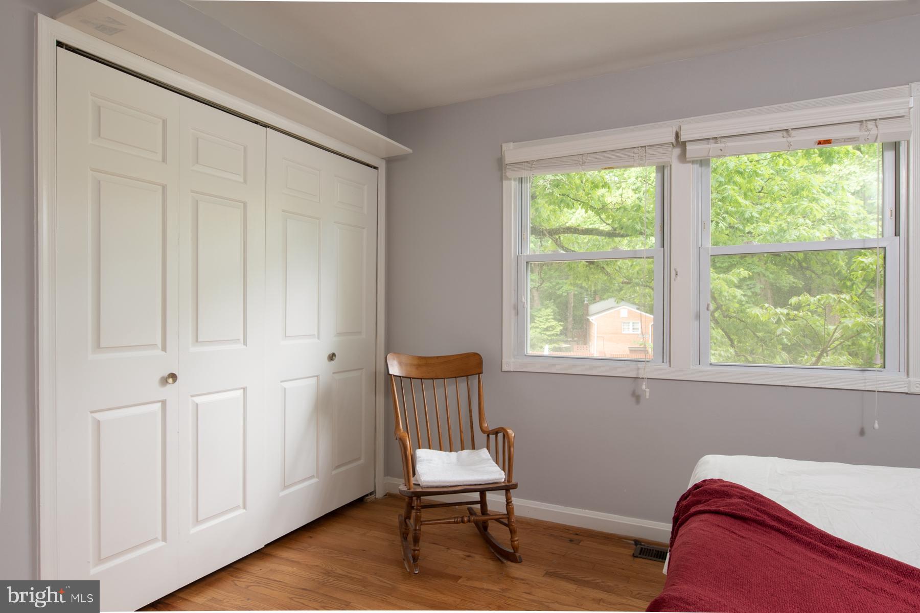 8603 Bradford Road, Unit 105 Silver Spring, MD 20901 - Photo 20 of 36 a room with a bed and a chair
