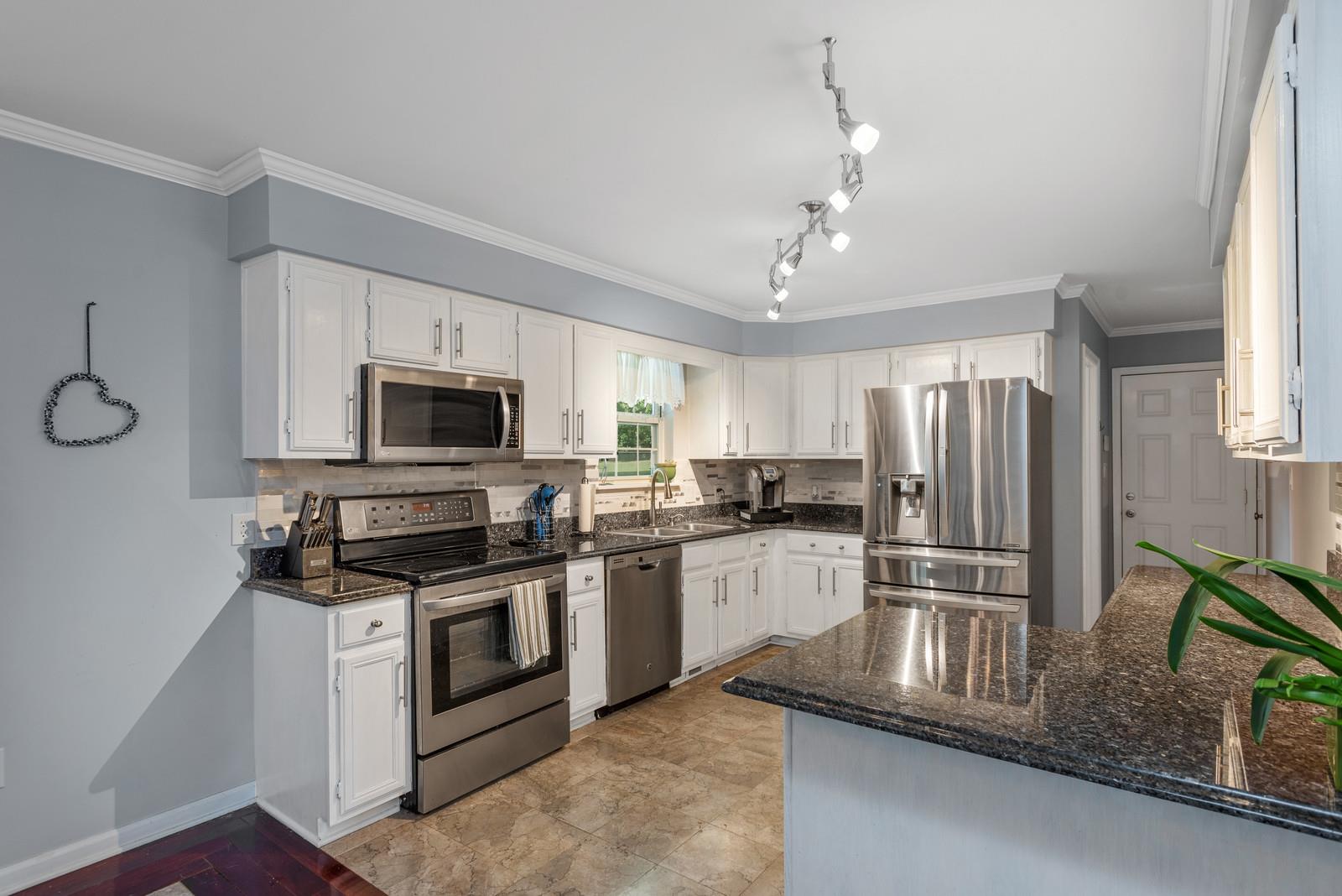 682 Baker Road Columbia, TN 38401 - Photo 10 of 30 a kitchen with stainless steel appliances granite countertop a stove a refrigerator and a microwave