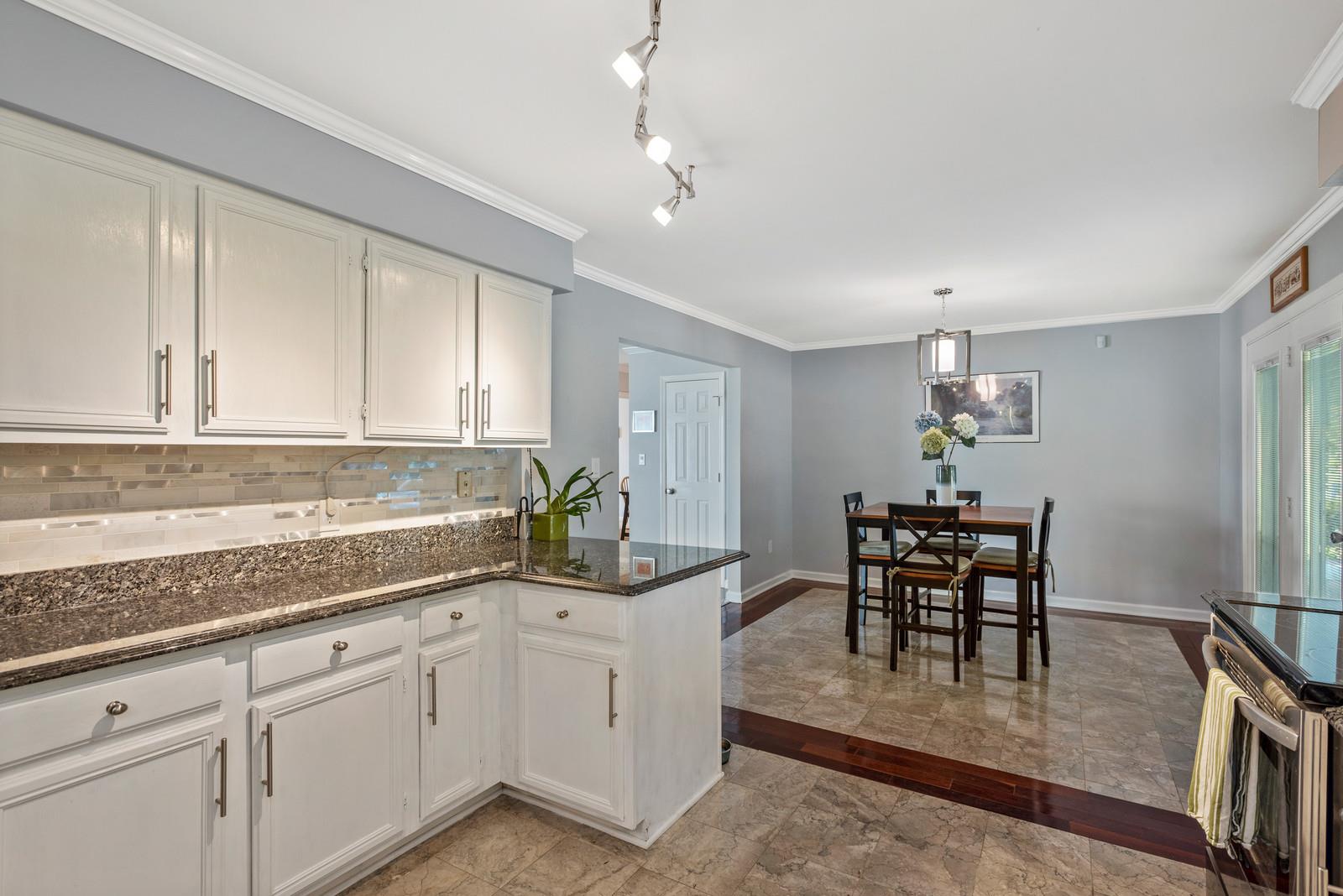682 Baker Road Columbia, TN 38401 - Photo 14 of 30 a kitchen with granite countertop cabinets and chair in it
