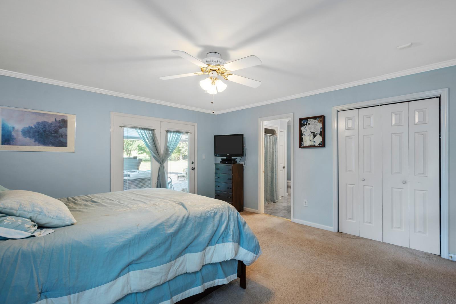 682 Baker Road Columbia, TN 38401 - Photo 17 of 30 a bedroom with a bed and a chandelier