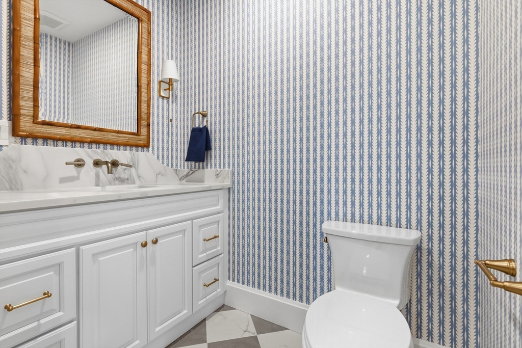 847 East 5th Street, Unit 2 Boston, MA 02127 - Photo 14 of 24 a bathroom with a toilet sink vanity and mirror