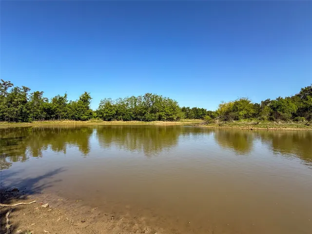 a view of a lake with houses in the background