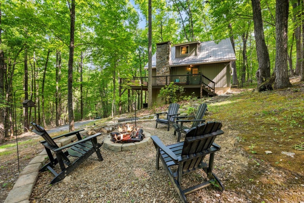 216 Saddle Lane Deep Gap, NC 28618 - Photo 3 of 44 a backyard of a house with table and chairs