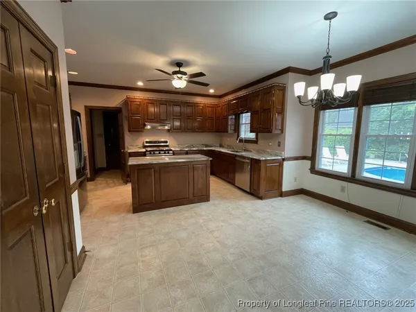 a large kitchen with cabinets and stainless steel appliances