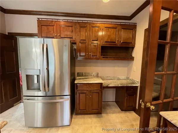 a kitchen with granite countertop a sink a counter top space appliances and cabinets