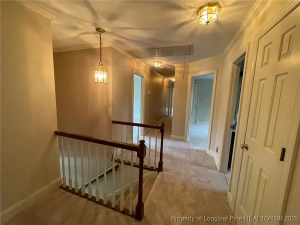 an empty room with windows and ceiling fan