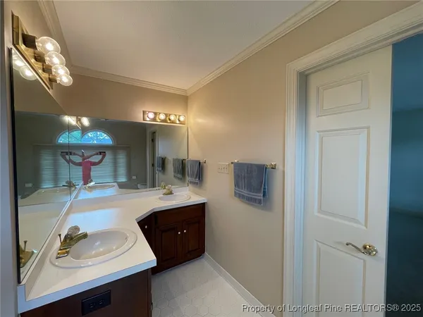 a bathroom with a tub a sink shower and mirror