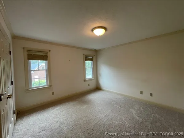 an empty room with windows and closet