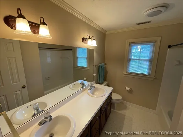 a bathroom with a toilet and shower