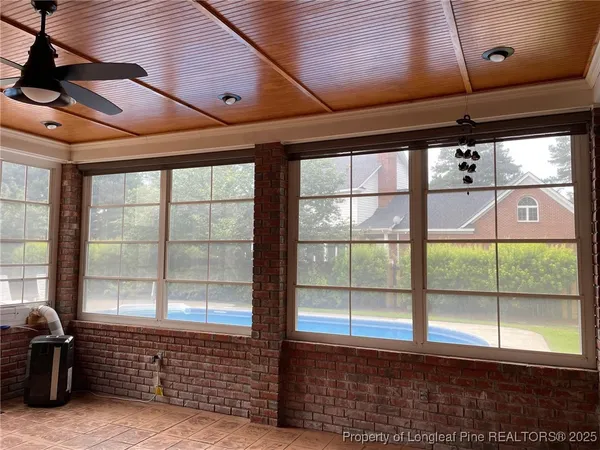 a view of a swimming pool with yard in front of house