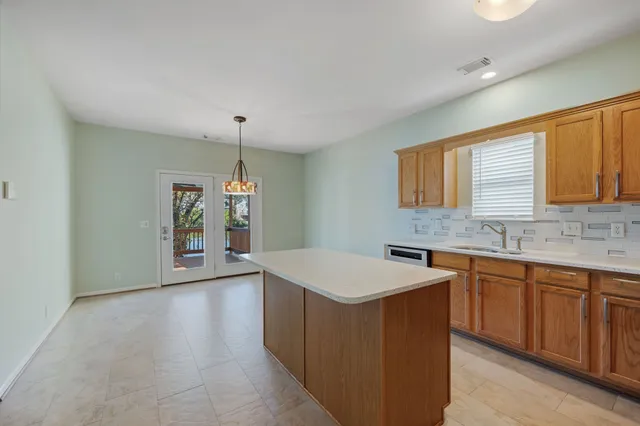 a kitchen with a sink a counter top space and cabinets
