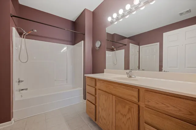 a bathroom with a tub a sink and mirrors