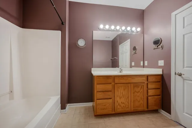 a bathroom with a double vanity sink and a mirror