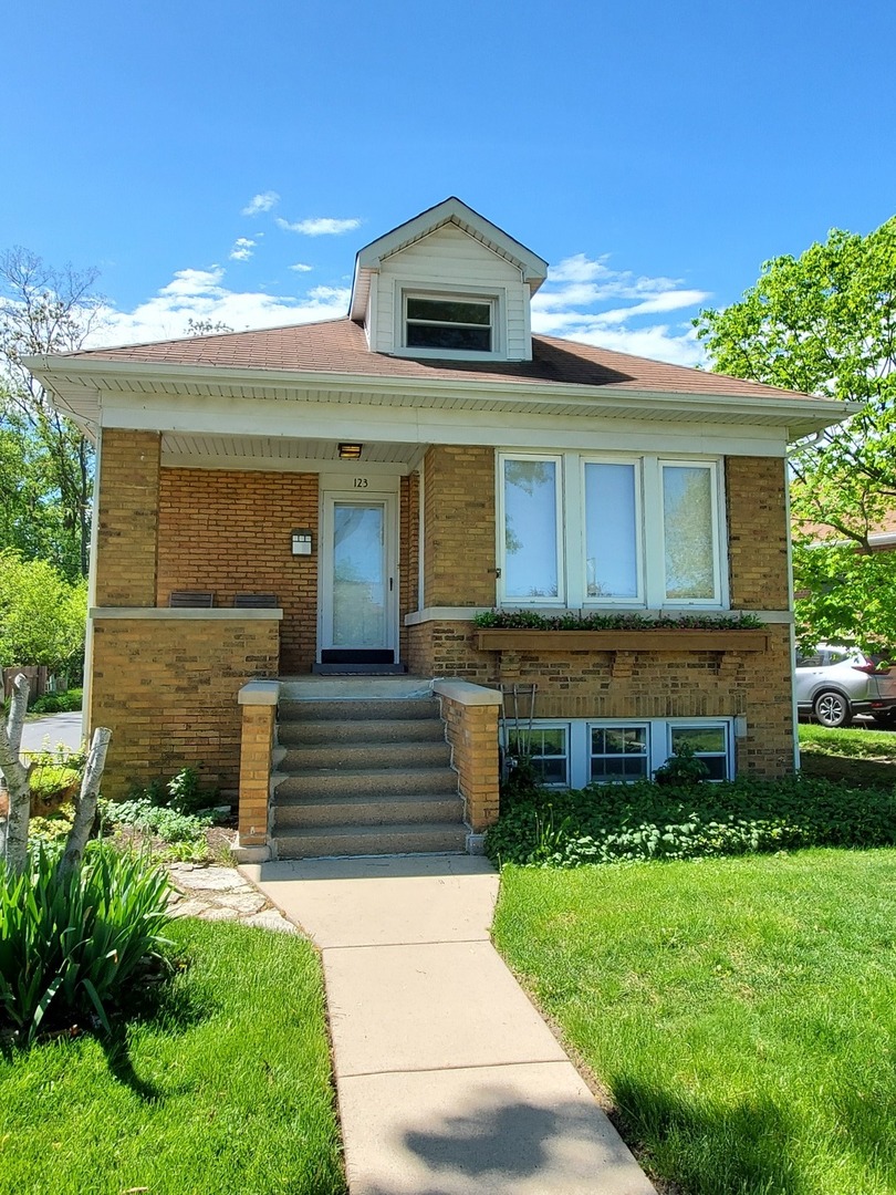 123 Northgate Road Riverside, IL 60546 - Photo 1 of 29 a front view of a house with a yard