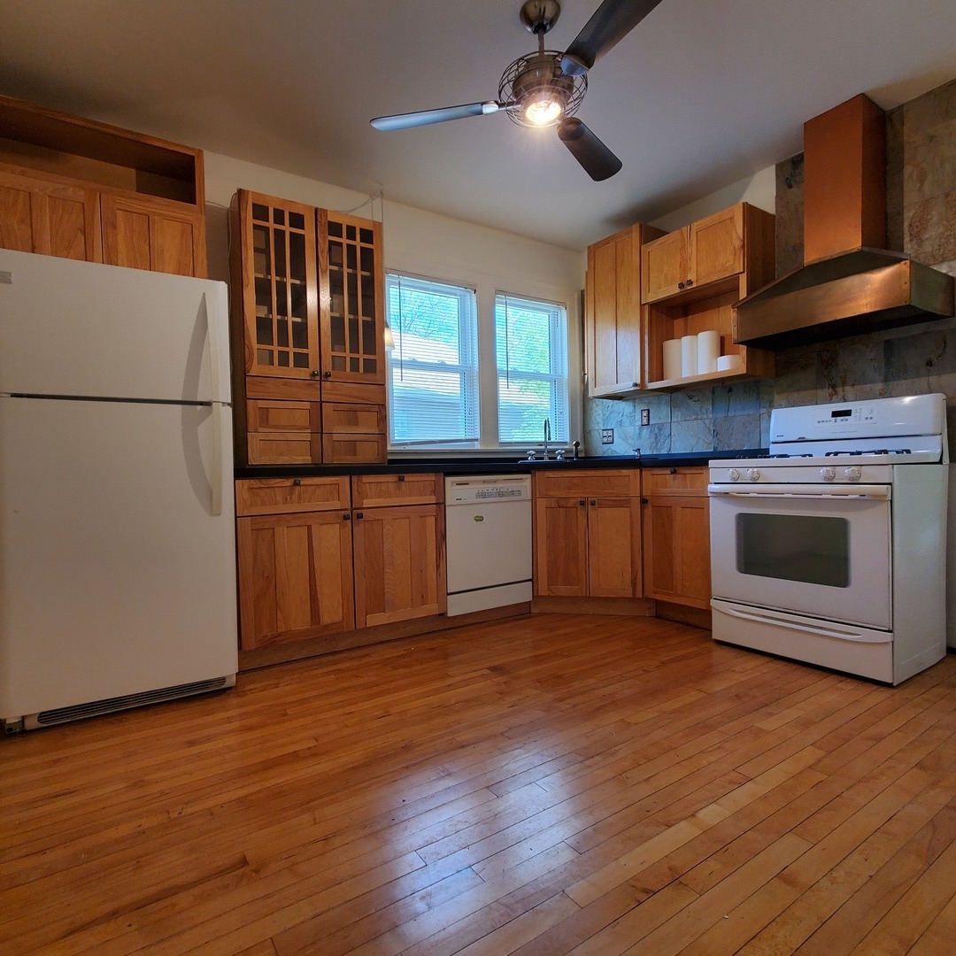 123 Northgate Road Riverside, IL 60546 - Photo 12 of 29 a kitchen with stainless steel appliances granite countertop a stove top oven a sink and a refrigerator