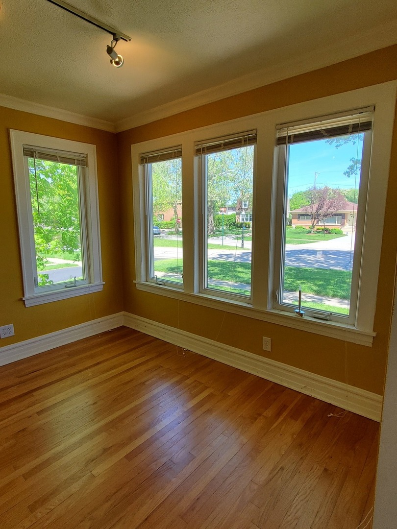 123 Northgate Road Riverside, IL 60546 - Photo 8 of 29 a view of an empty room with wooden floor and a window