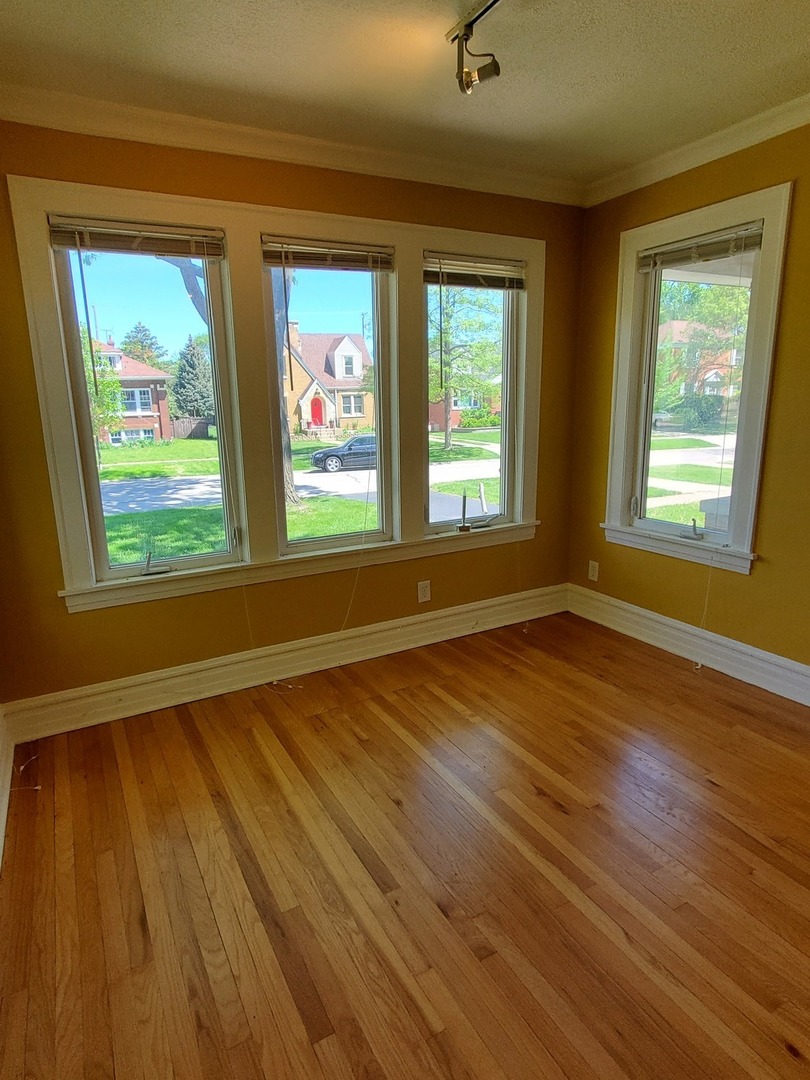 123 Northgate Road Riverside, IL 60546 - Photo 9 of 29 a view of an empty room with wooden floor and a window