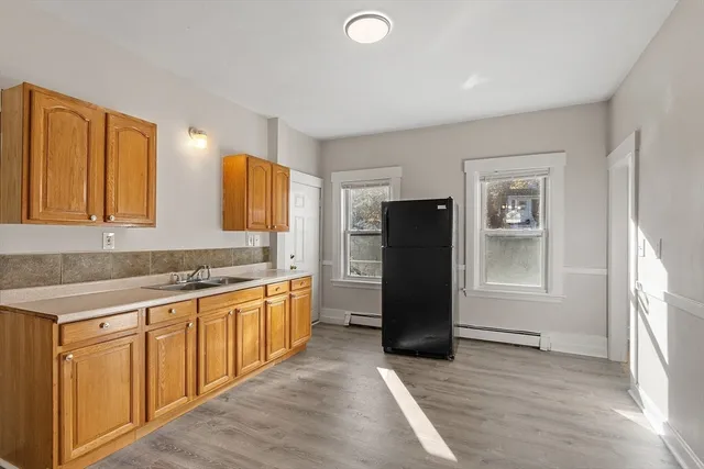 a kitchen with stainless steel appliances granite countertop a refrigerator and a stove top oven