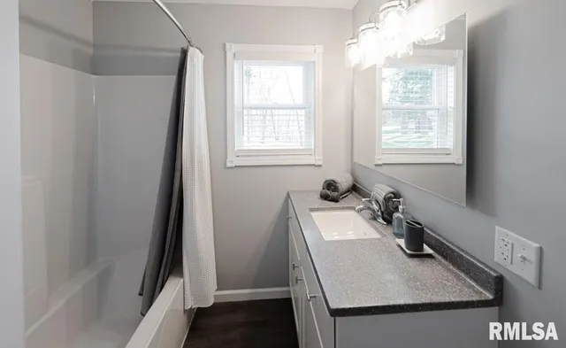a bathroom with a sink and a window