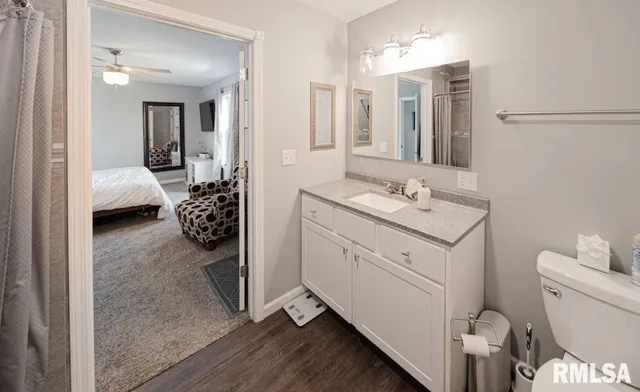 a en suite bathroom with a toilet sink and mirror