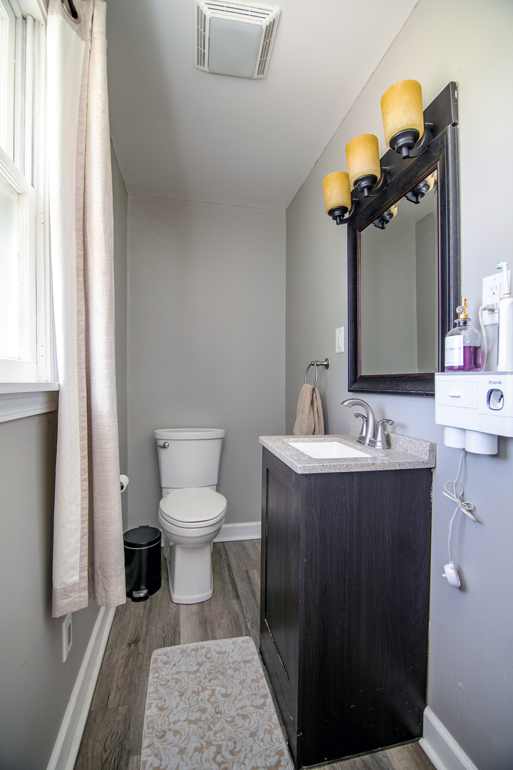 1572 North 2000E Road Bourbonnais, IL 60914 - Photo 10 of 18 a bathroom with a sink a toilet and mirror
