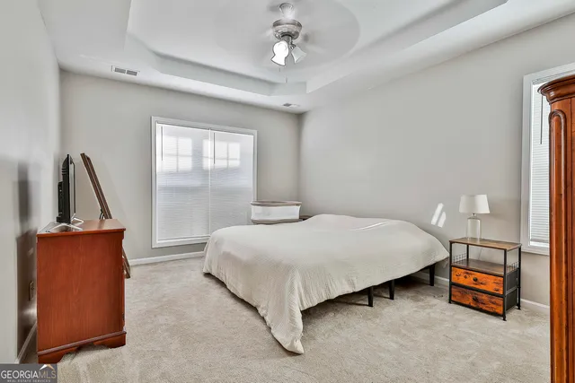 a bedroom with a bed and a dresser with mirror