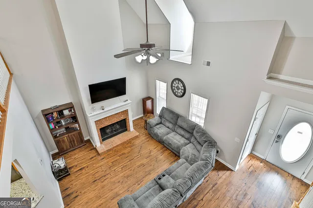 a living room with furniture a fireplace and a flat screen tv