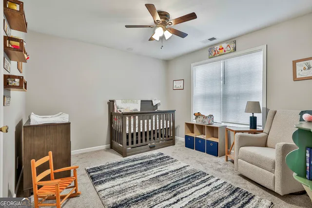 a bedroom with furniture and a rug