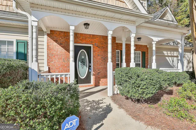 a front view of a house with garden