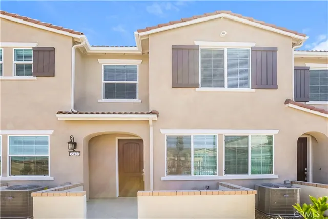 a front view of a house with large windows
