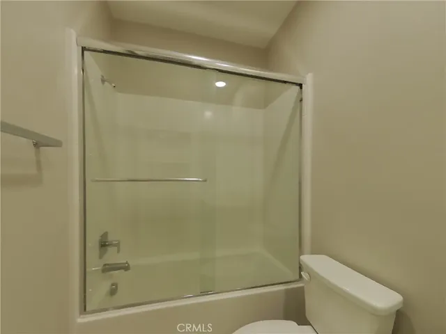 a bathroom with a shower a toilet and sink