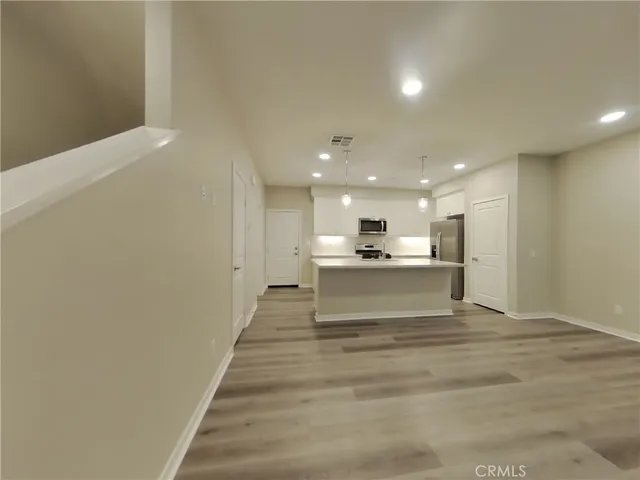 a view of kitchen and kitchen with windows