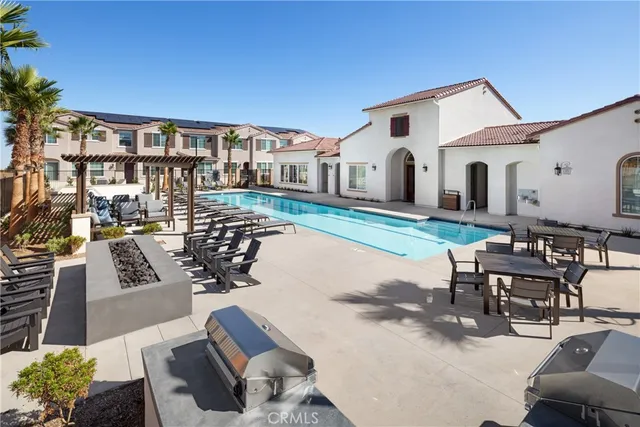 a view of a patio with couches table and chairs and potted plants